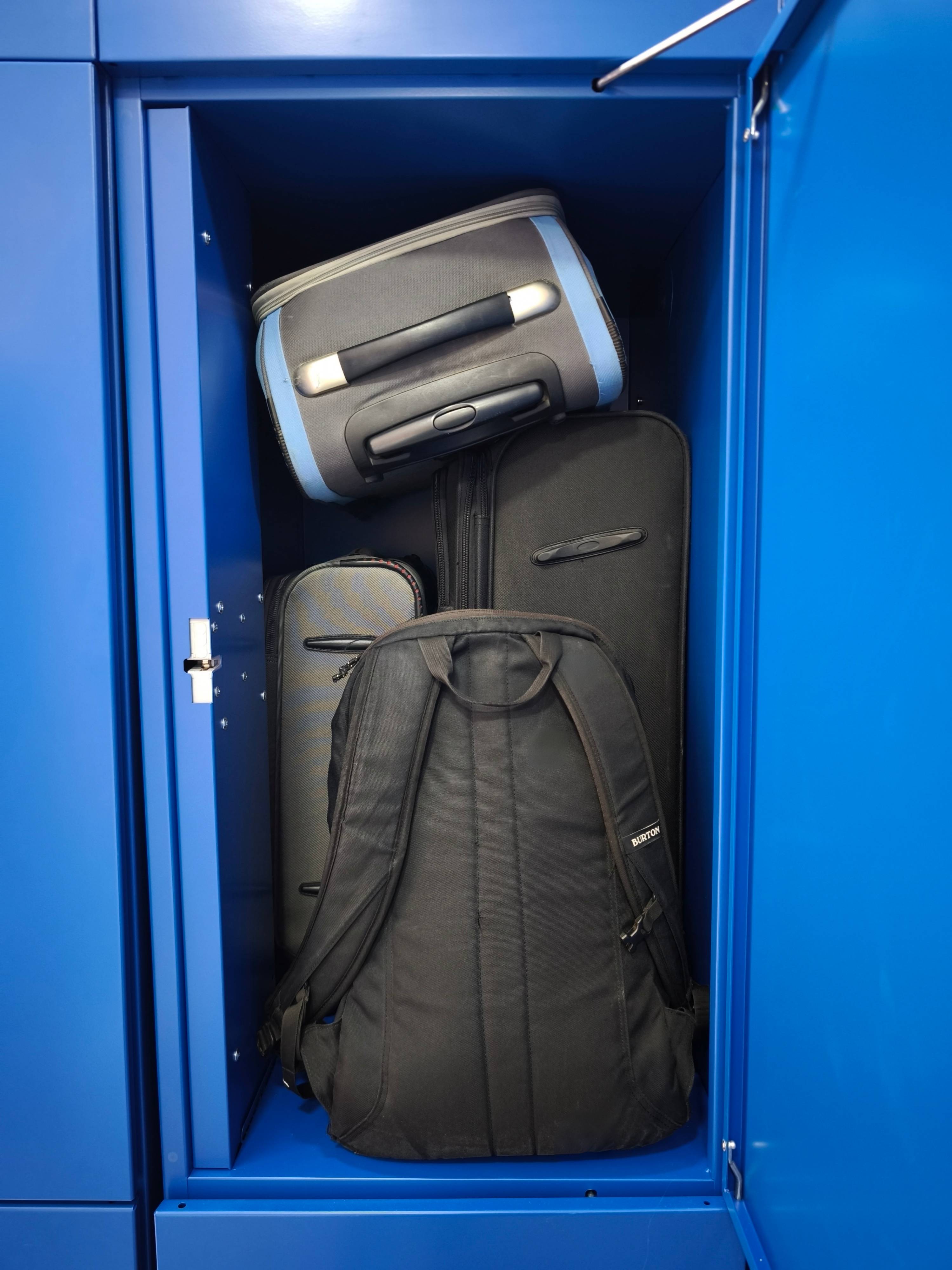 Photo of a filled large locker compartment in a bank of automated lockers